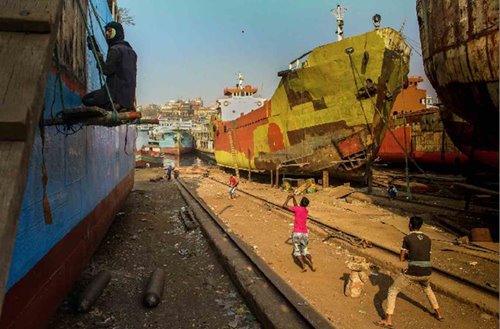 dockyard workers’ children playing cricket near the Buriganga River in Keraniganj, Dhaka, Bangladesh