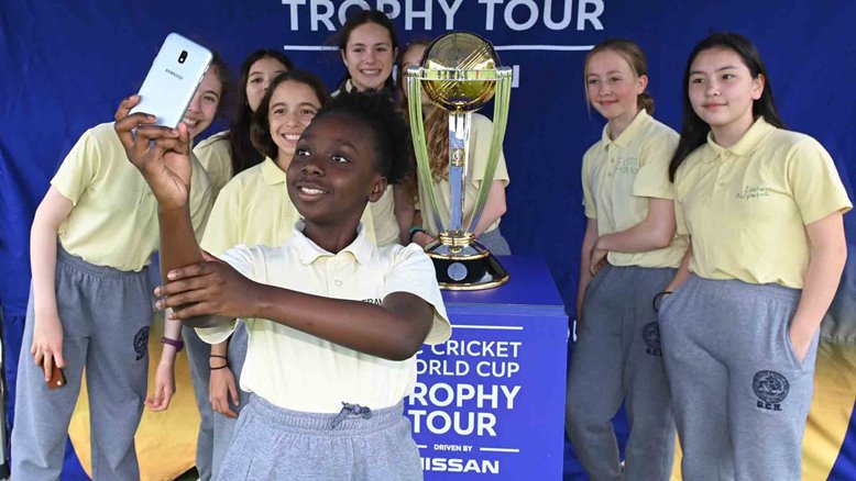 Local school children pose with the World Cup trophy.