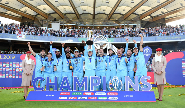 Eoin Morgan lifts the Cricket World Cup trophy in front of the Warner Stand