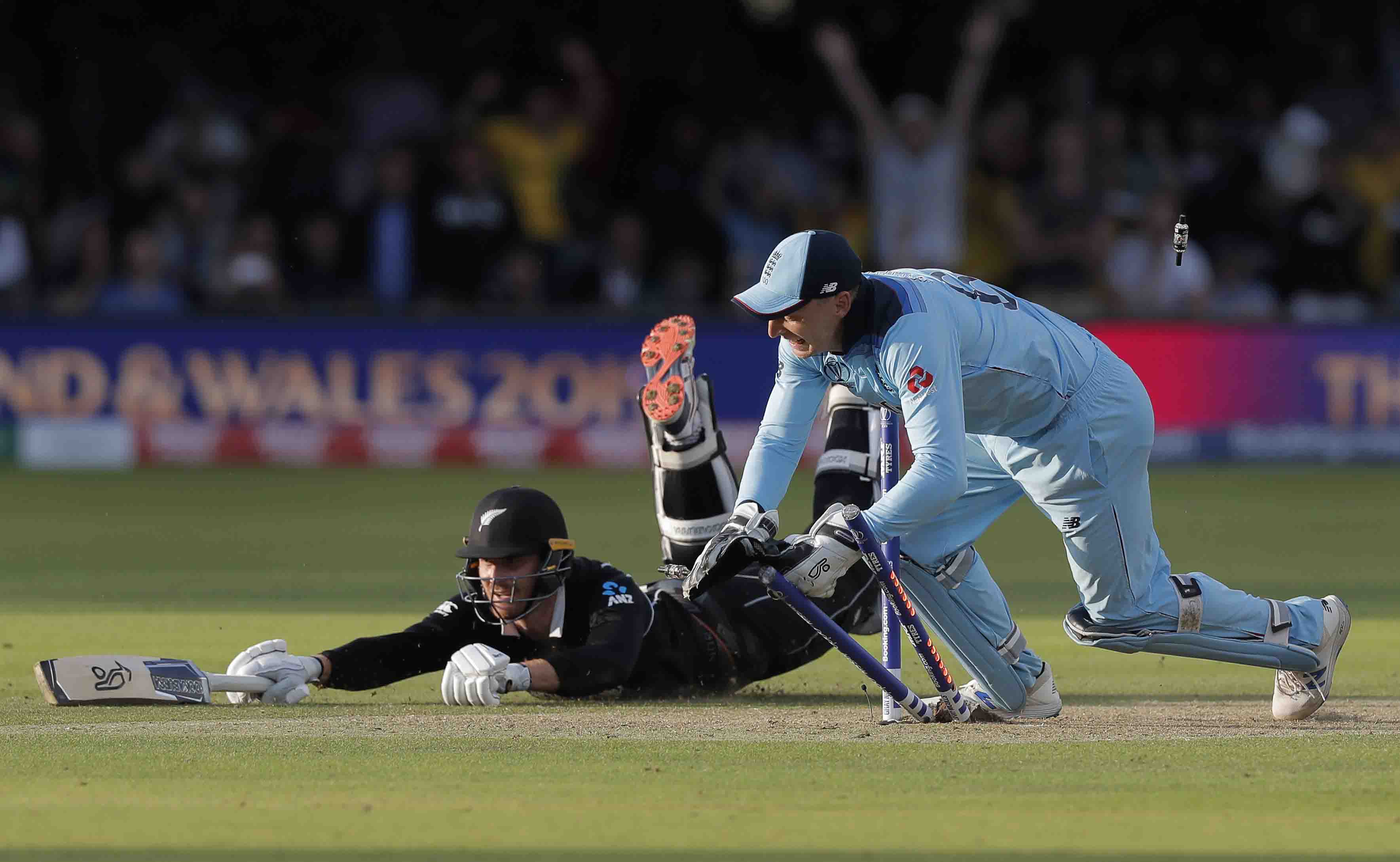 England wicketkeeper Jos Buttler runs out New Zealand’s Martin Guptill off the last ball of the Super Over to secure victory for England at the ICC Men’s Cricket World Cup Final at Lord’s.