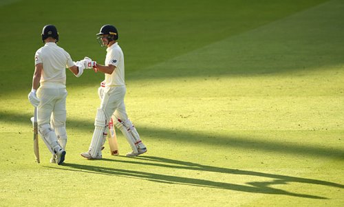 Rory Burns and Jack Leach leave the field after Day 1.