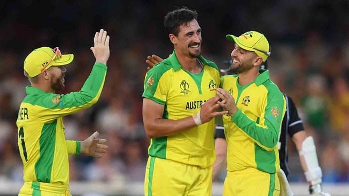 Mitchell Starc celebrates with team mates.