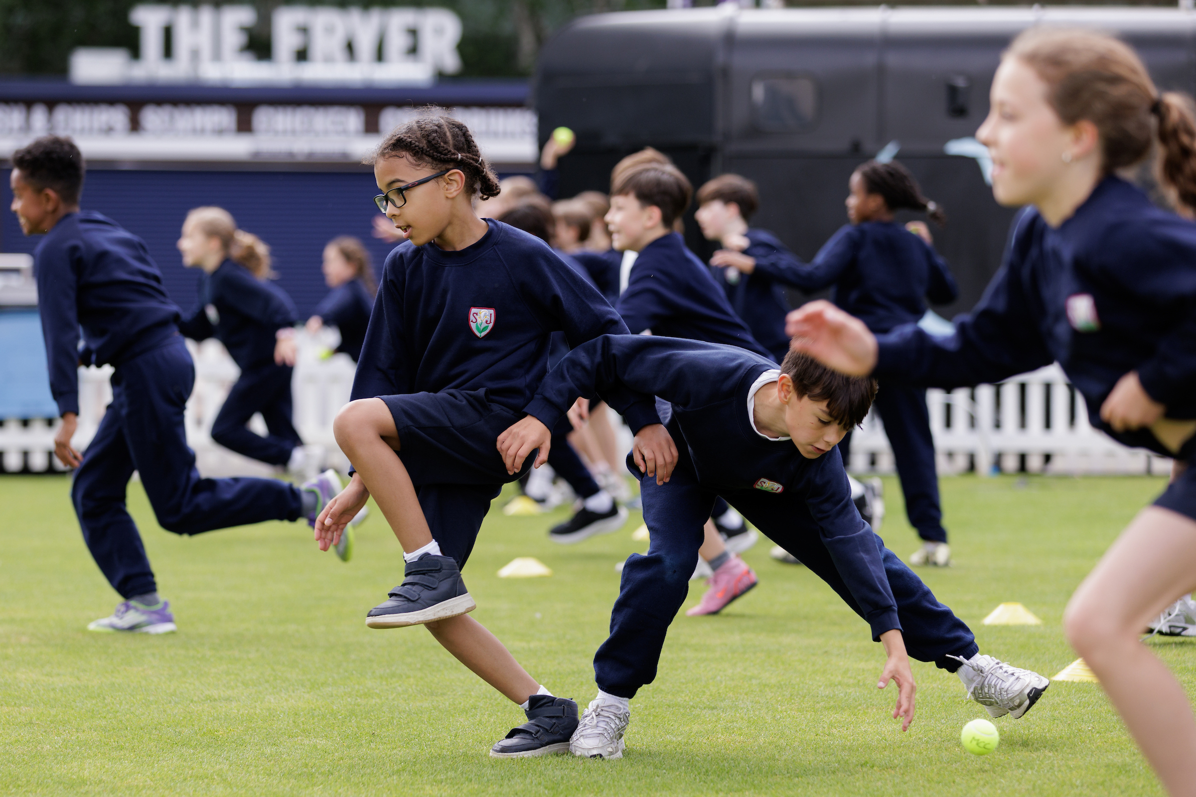 Schoolchildren playing at Lord's with Harry Judd